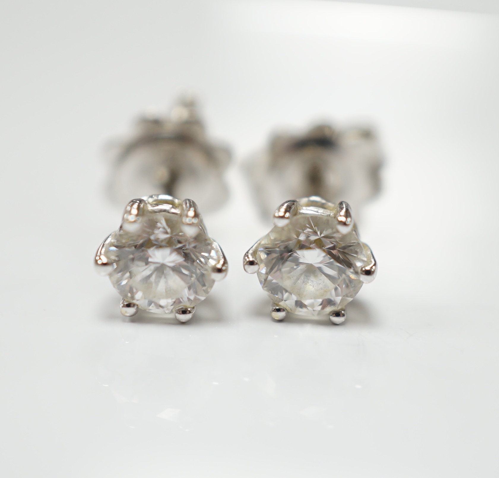 A pair of 18ct white gold and solitaire diamond set ear studs